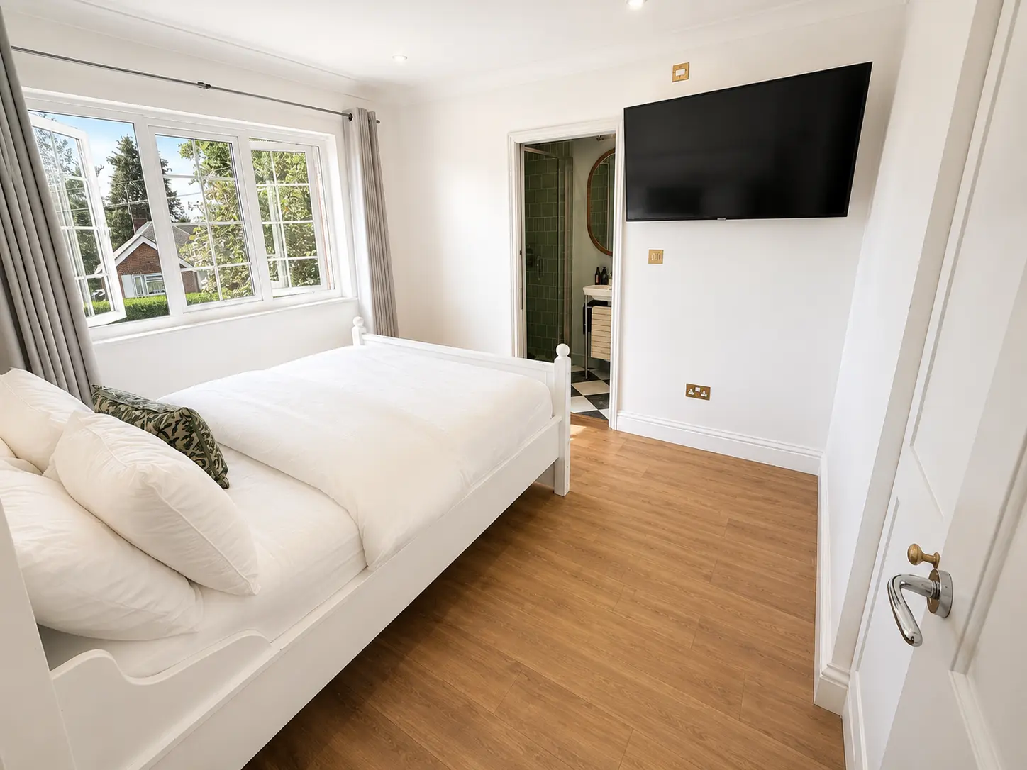 Double bedroom with a television and its own en-suite shower room